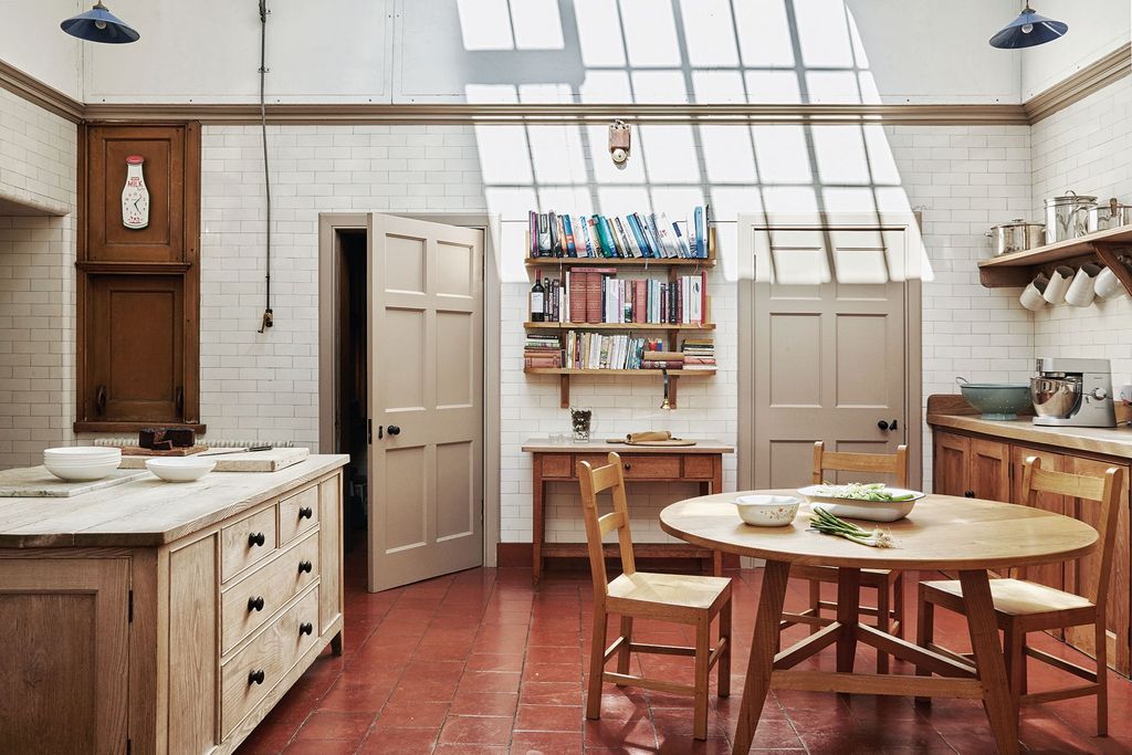 Image may contain Furniture Flooring Wood Floor Interior Design Indoors Dining Table Table Chair Room and Housing