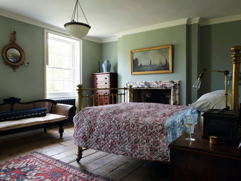 Image may contain Furniture Indoors Room Bedroom Bed Flooring Rug and Living Room