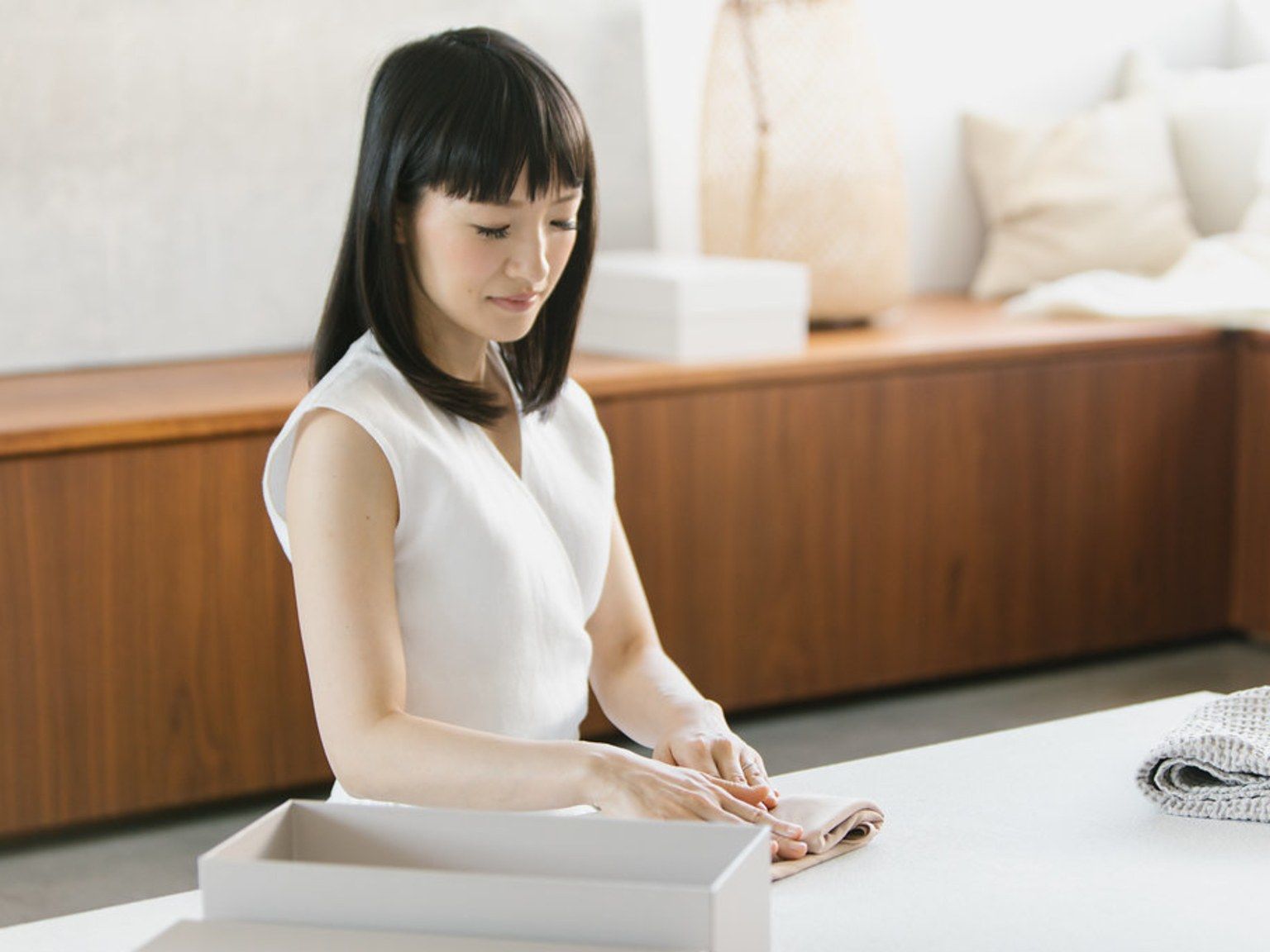 Image may contain Marie Kondo Human Person Sitting Furniture and Table