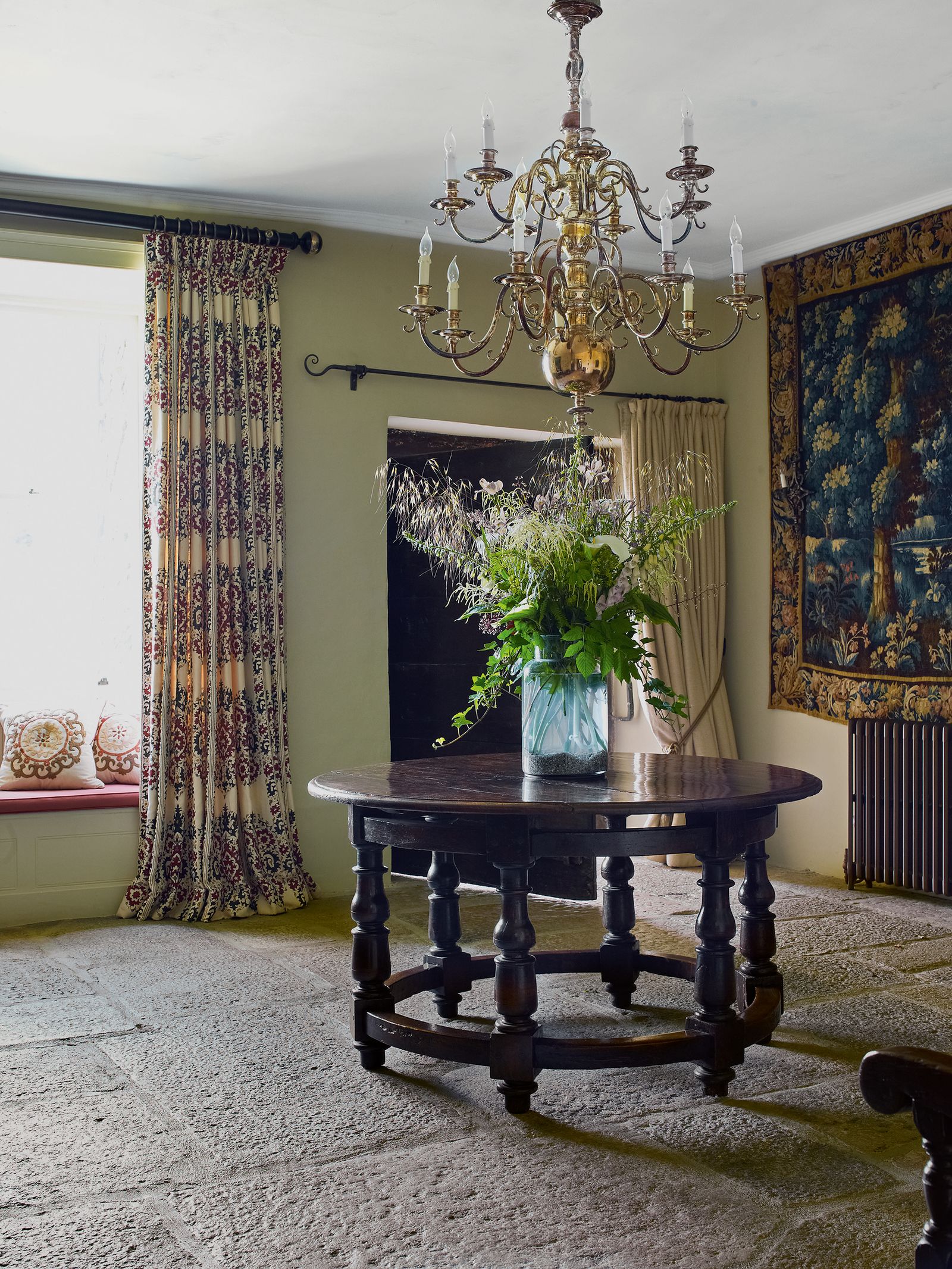 Image may contain Living Room Room Indoors Interior Design Furniture Lamp Chandelier Flooring Table and Plant
