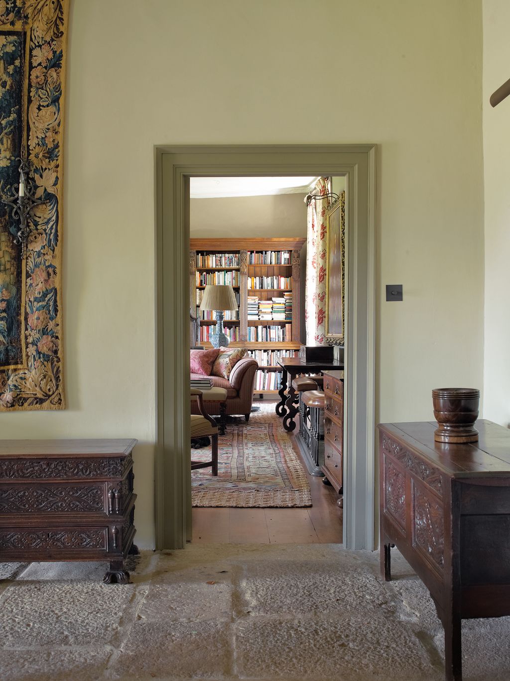 Image may contain Furniture Living Room Room Indoors Bookcase Shelf and Interior Design