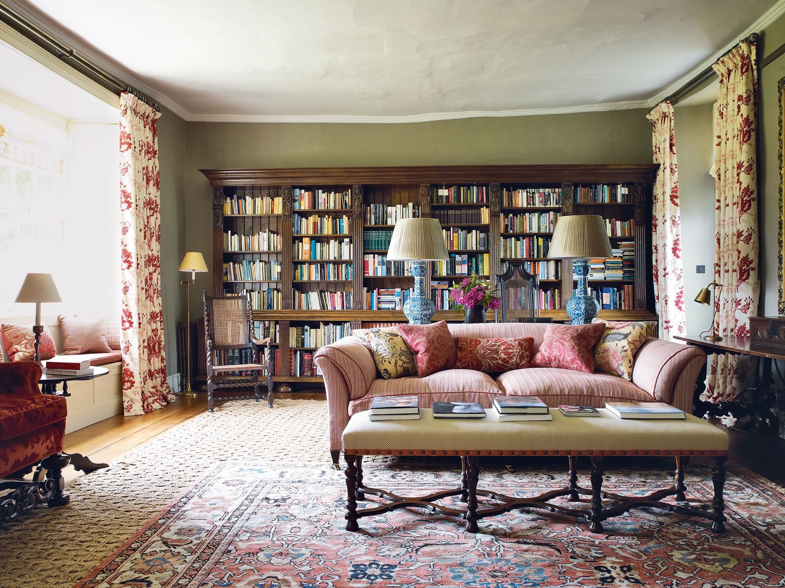 Image may contain Furniture Couch Living Room Indoors Room Rug Bookcase and Table