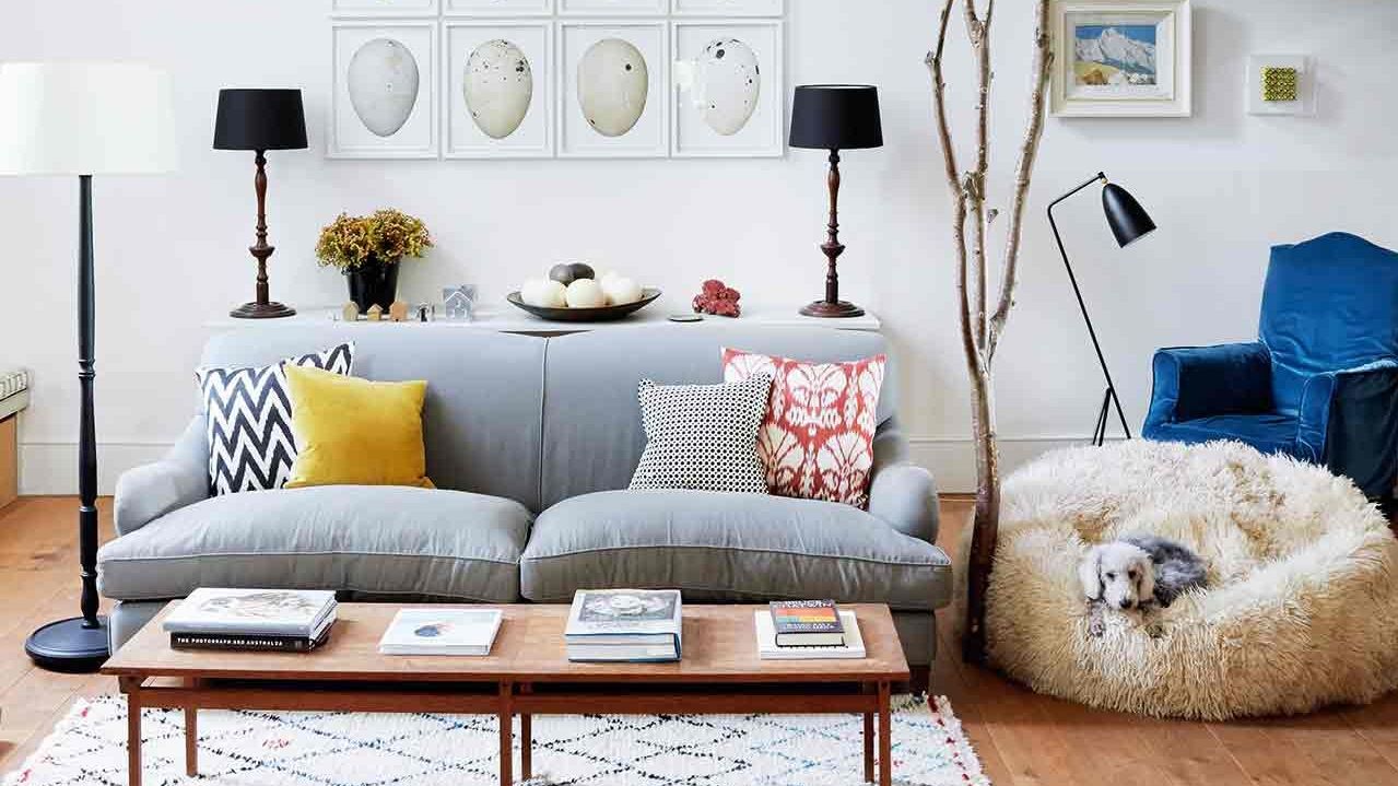 Image may contain Furniture Living Room Indoors Room Cushion Pillow Rug Table and Couch