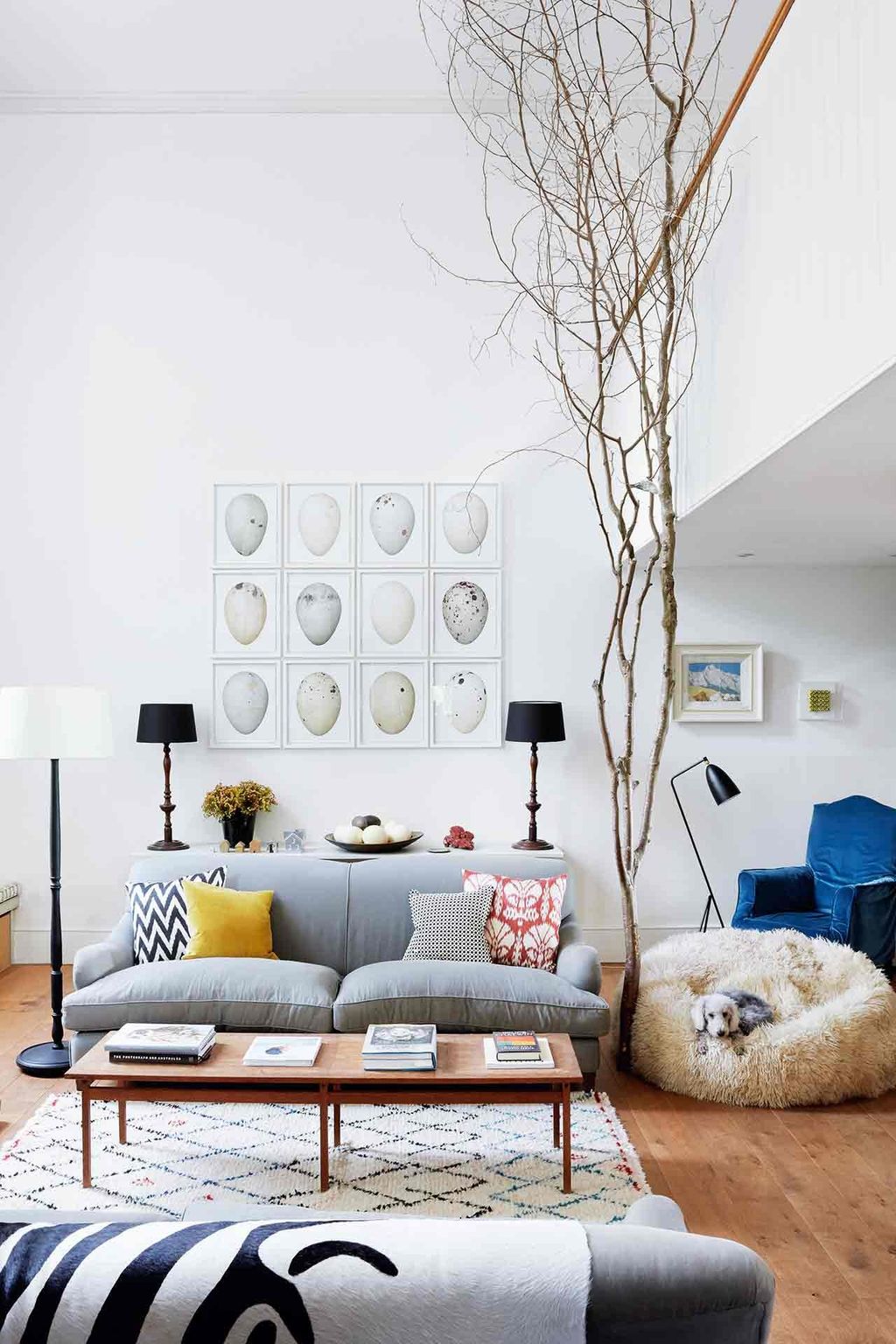 Image may contain Furniture Living Room Indoors Room Cushion Pillow Rug Table and Couch