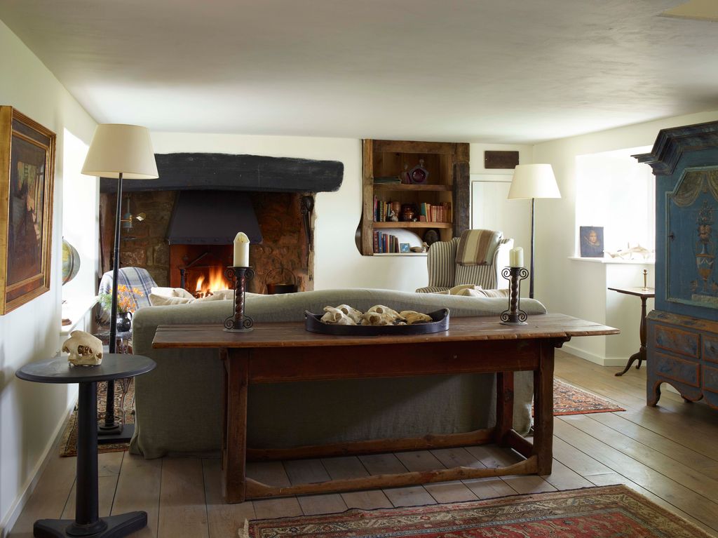 Image may contain Flooring Wood Living Room Room Indoors Hardwood Hearth Fireplace Furniture and Floor