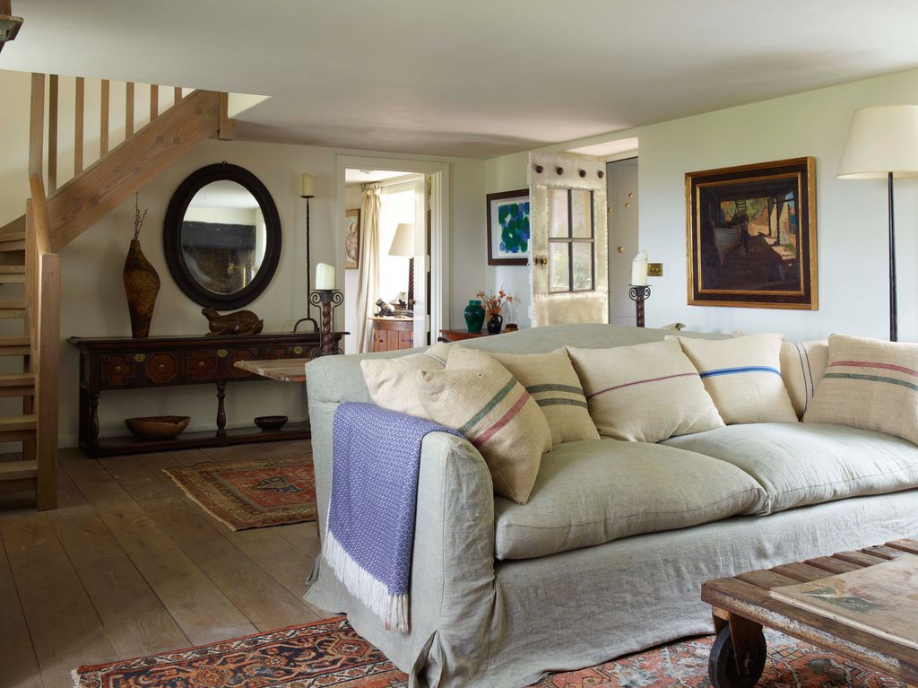 Image may contain Living Room Room Indoors Furniture Couch Flooring Interior Design Wood Table and Hardwood