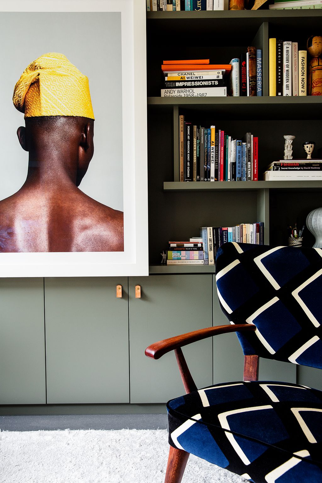 Image may contain Furniture Shelf Chair Bookcase Interior Design Indoors Human and Person