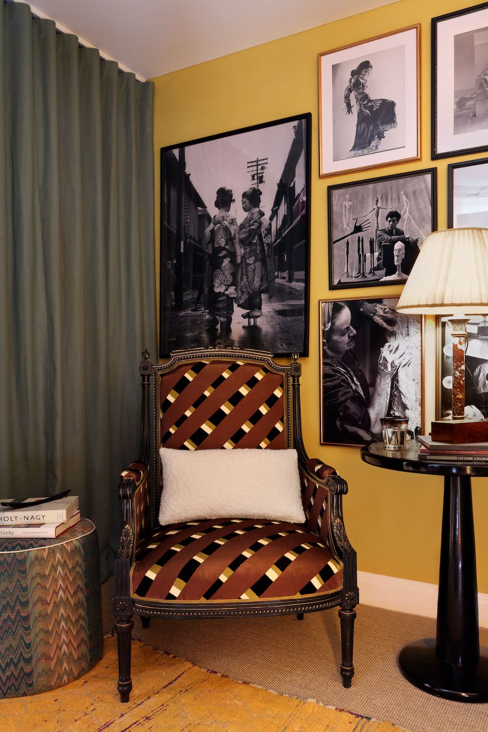 Image may contain Furniture Human Person Chair Home Decor Lamp Table Lamp Living Room Indoors and Room