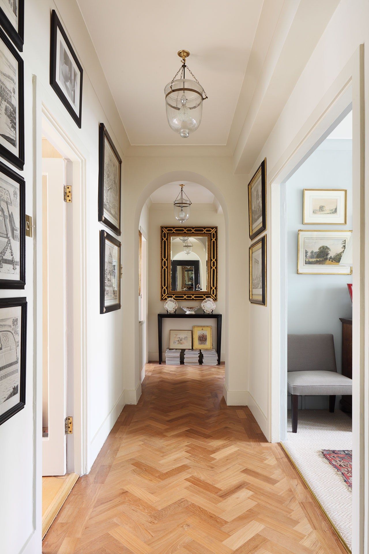 Image may contain Flooring Floor Corridor Wood Hardwood Rug and Art