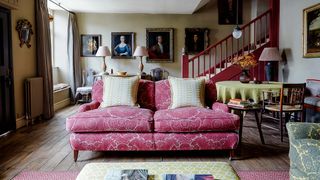 Image may contain Couch Furniture Living Room Indoors Room Human Person Chair Cushion and Rug