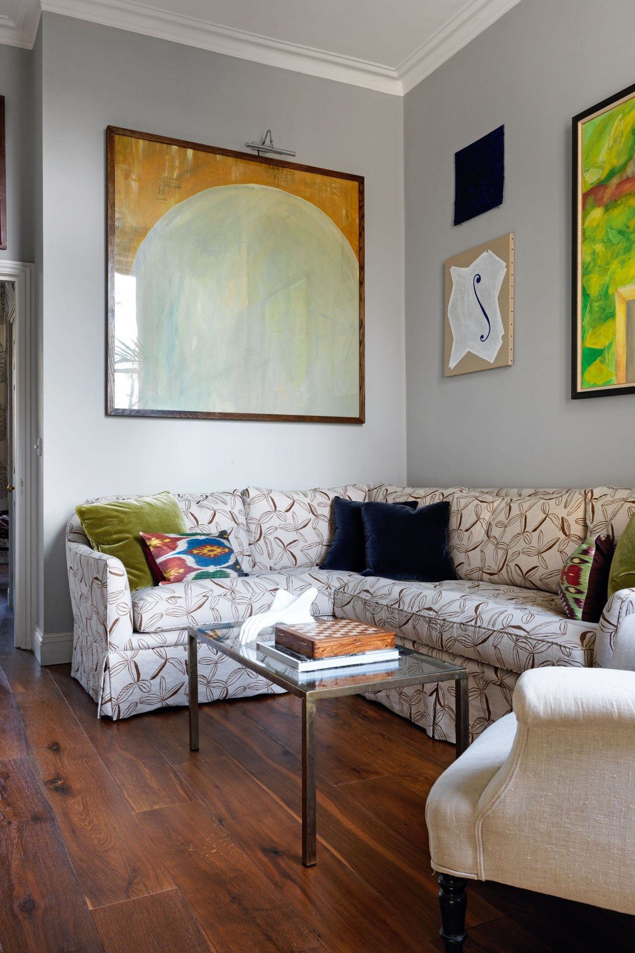 Image may contain Living Room Room Indoors Furniture Couch Wood Flooring Hardwood Table Interior Design and Rug