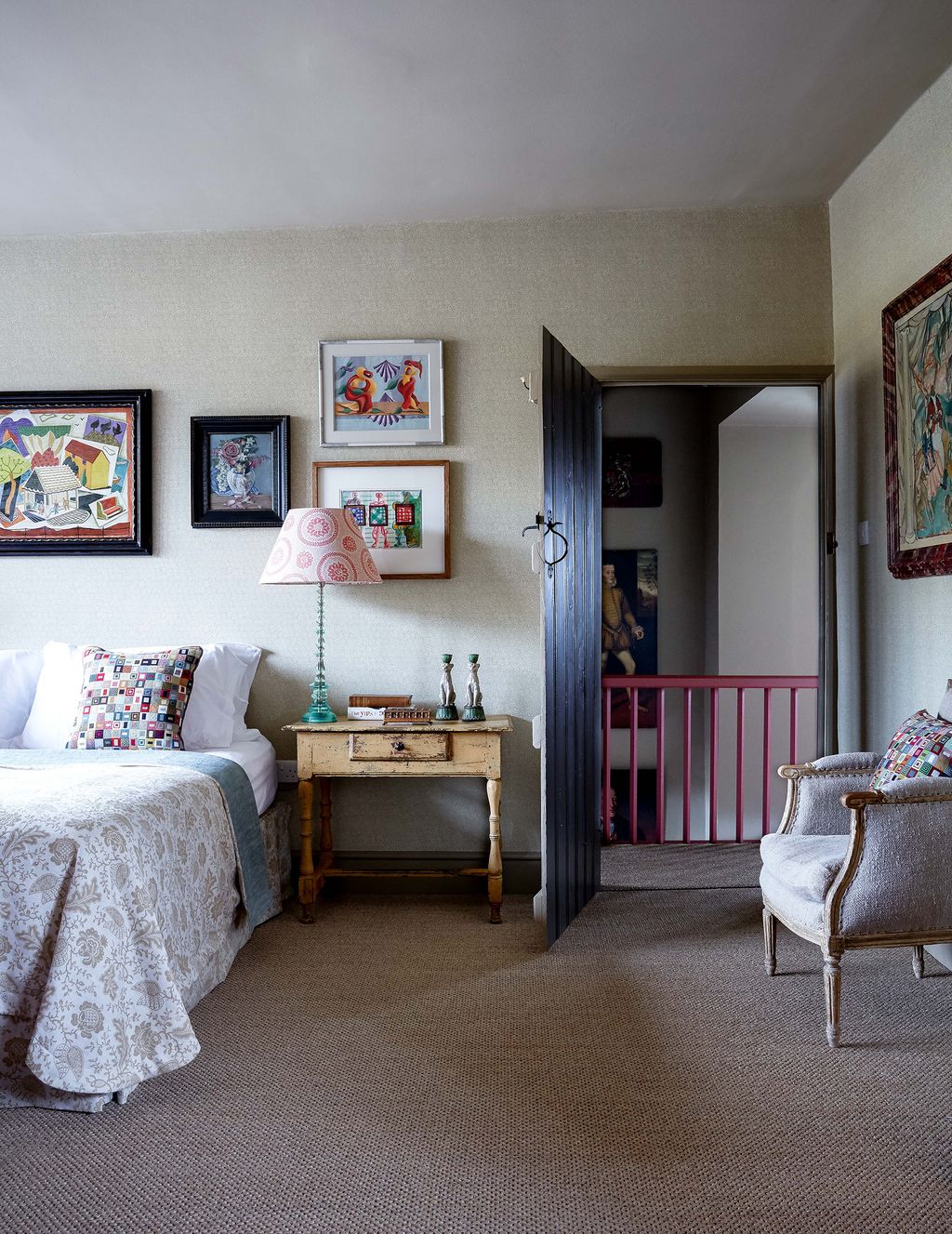 Paintings by artists including John Banting and Eileen Agar are displayed on walls papered in Robert Kimes ‘Cabbages. A...