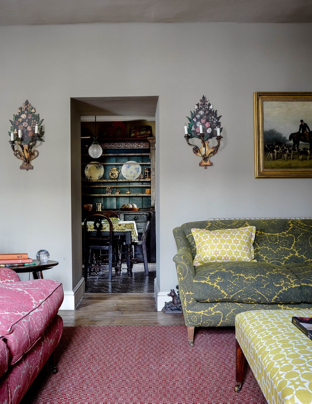 Image may contain Living Room Room Indoors Furniture Couch Interior Design Shelf Flooring Human Person and Cushion