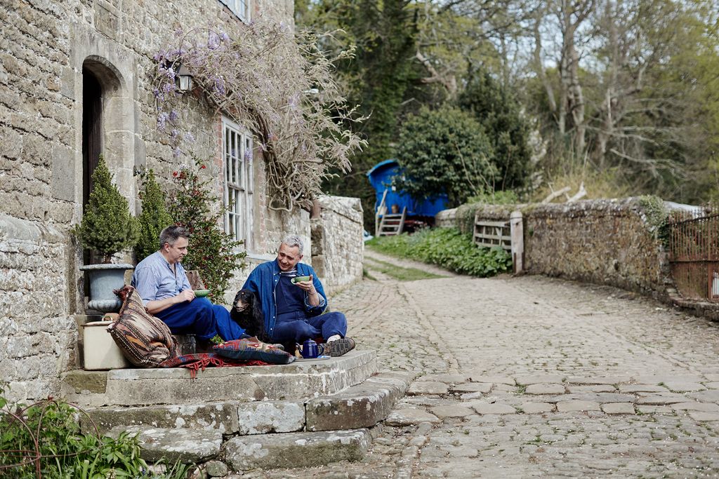 Image may contain Human Person Sitting Flagstone Path Walkway Clothing Apparel and Pants