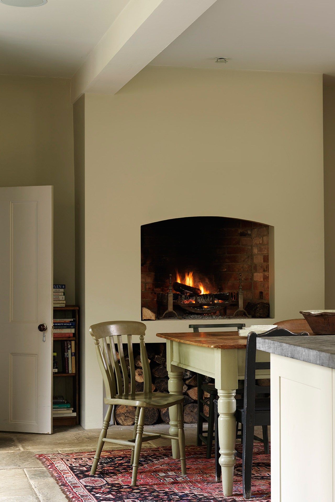 Image may contain Furniture Chair Fireplace Indoors Wood Hearth Hardwood Home Decor Flooring and Interior Design