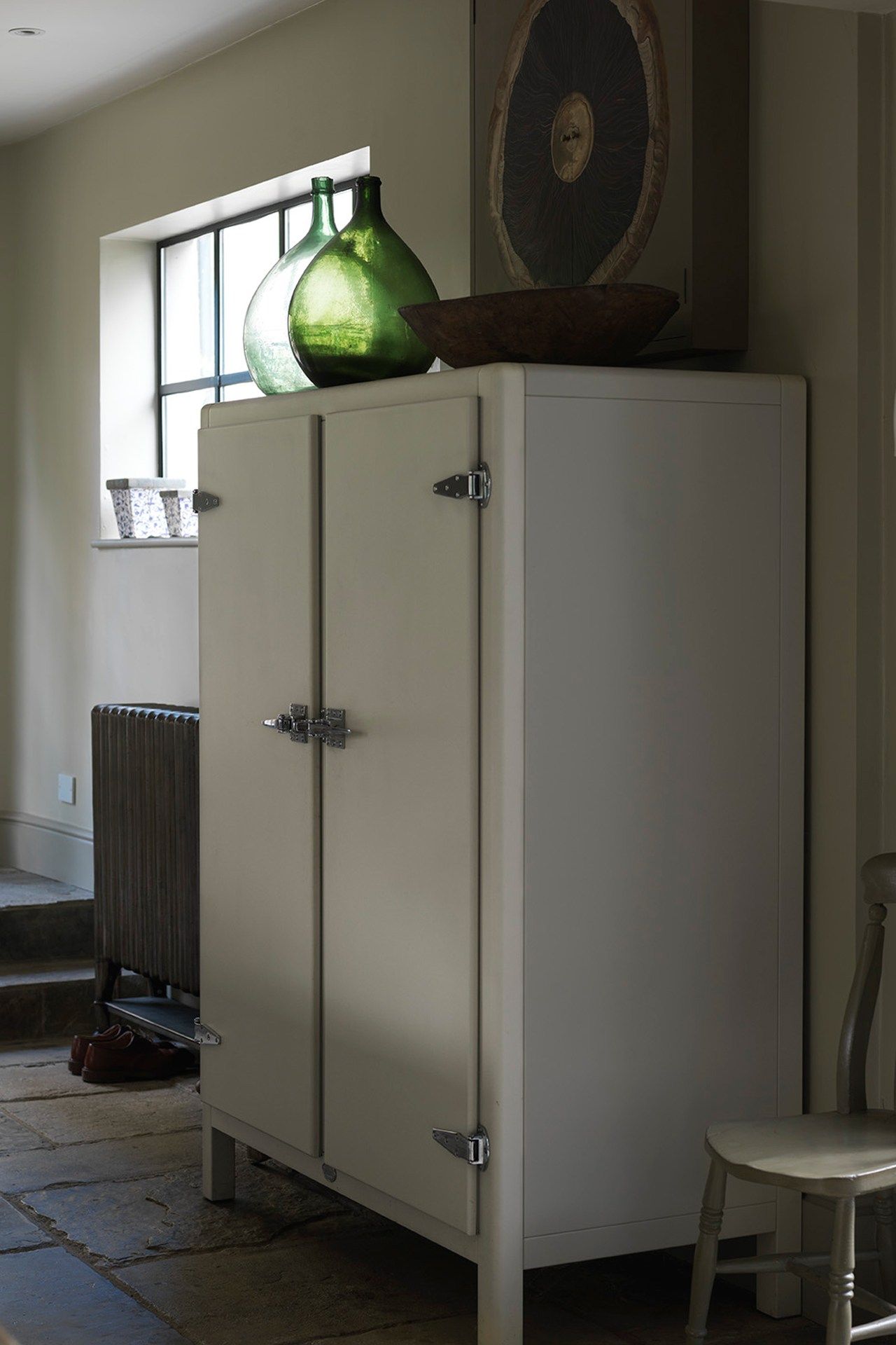 Image may contain Furniture Cupboard Closet Chair Appliance Refrigerator and Cabinet