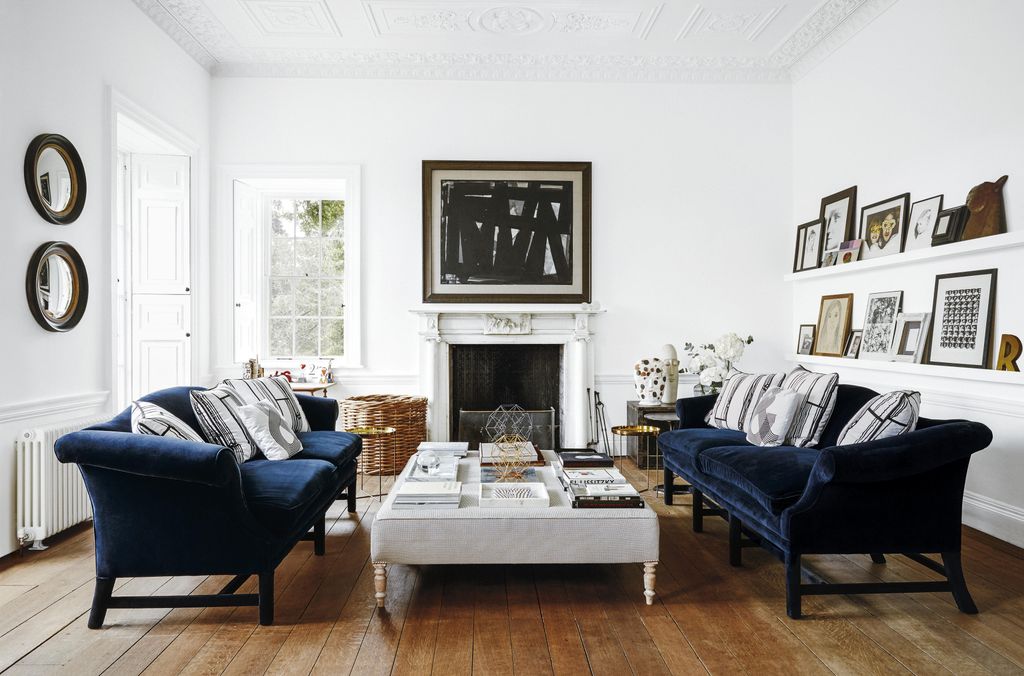 Image may contain Living Room Room Indoors Furniture Couch Flooring Wood Interior Design Table and Hardwood