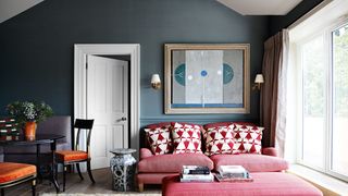 Image may contain Furniture Living Room Indoors Room Couch Chair Cushion Pillow Rug and Interior Design