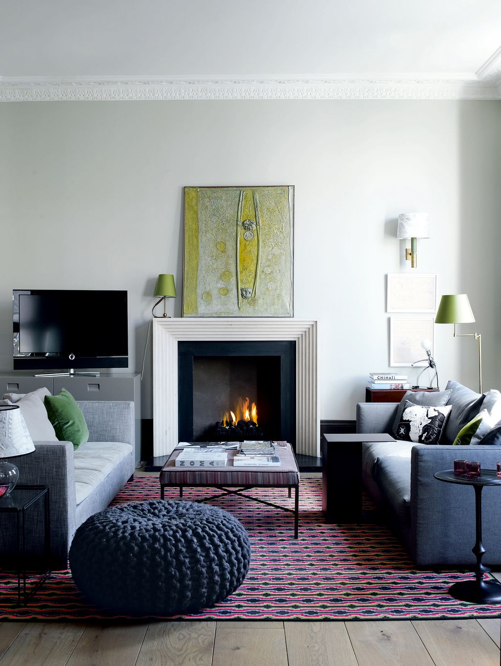 Image may contain Furniture Living Room Room Indoors Rug Interior Design Couch Fireplace Hearth Cushion and Pillow