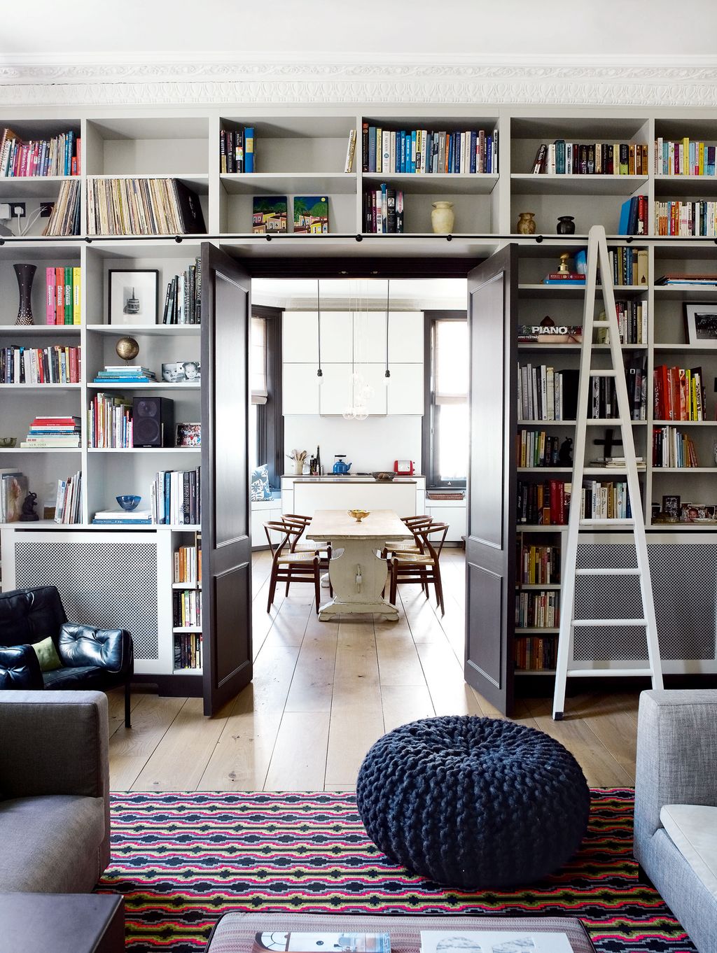 The doors opening from the drawing room into the kitchen are framed by custombuilt shelving which including the ladder...