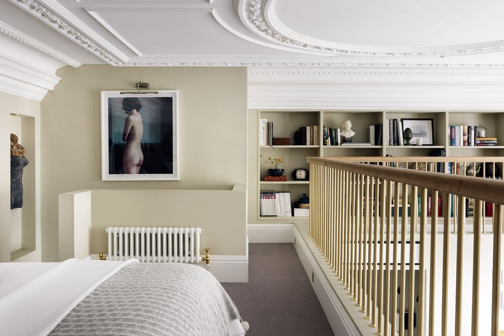 The mezzanine bedroom wraps around two sides of the flat.