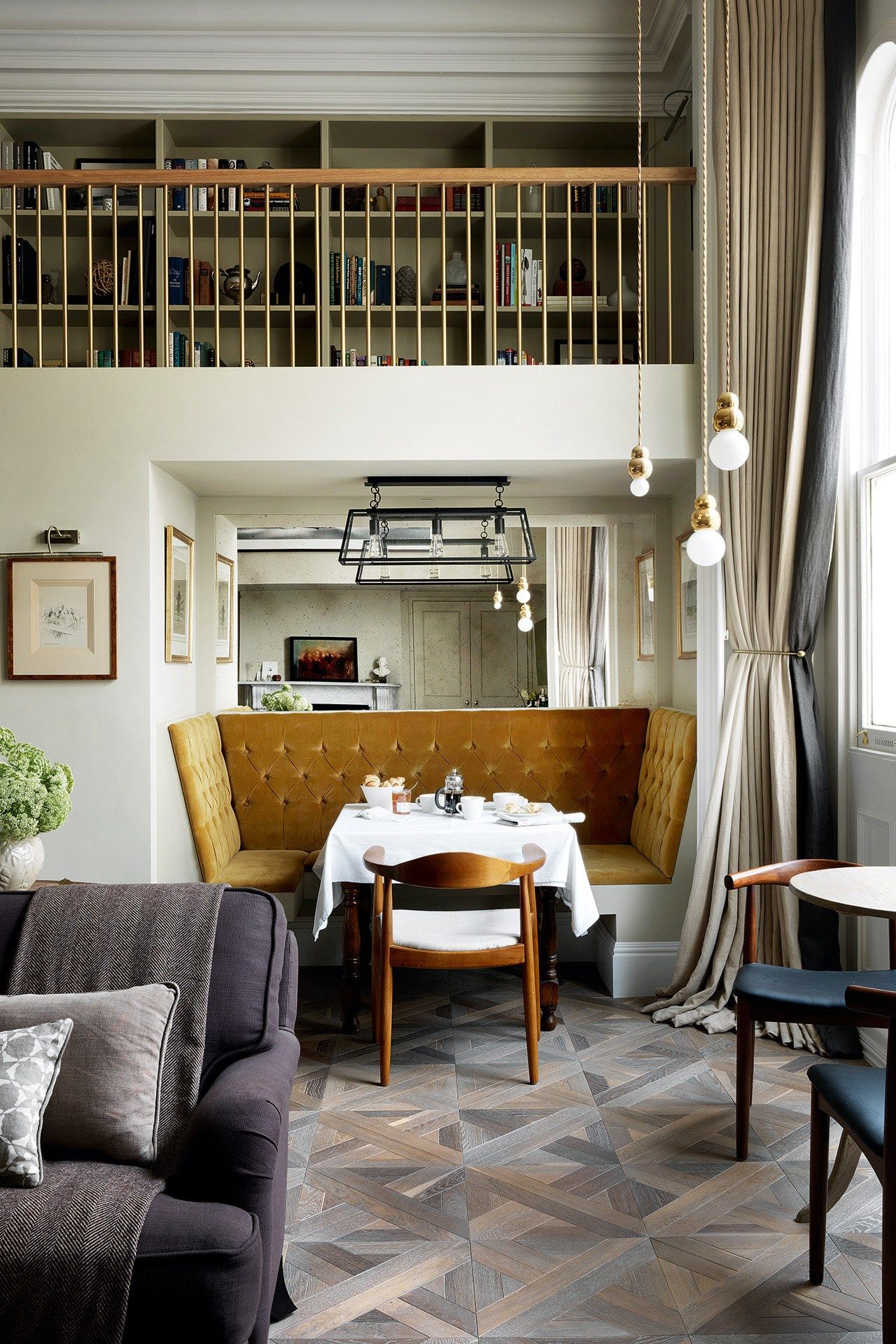 Image may contain Restaurant Furniture Cafe Interior Design Indoors Home Decor Living Room Room Wood and Couch