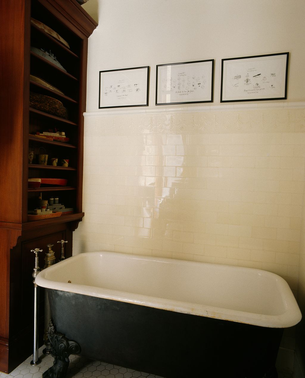 Pictures that Graydon drew for the children hang on the walls of their bathroom. Small boats are shelved beside a...