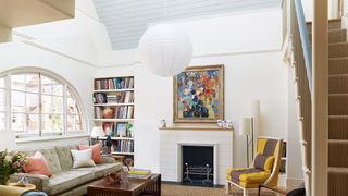 Image may contain Furniture Living Room Indoors Room Interior Design Home Decor Couch Hearth Chair and Fireplace