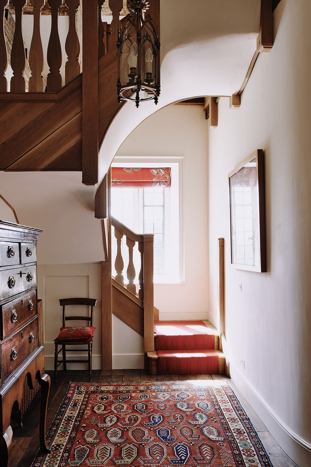 Image may contain Banister Handrail Interior Design Indoors Rug Wood Staircase Hardwood and Flooring
