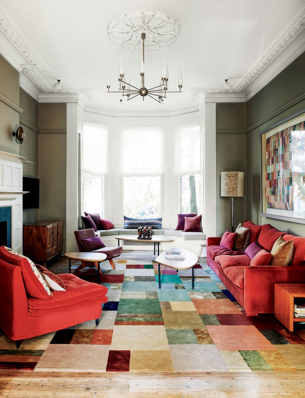 A ‘Hue rug from The Rug Company picks up on the pattern of the framed heirloom quilt on the wall. The orange velvet sofa...