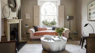 Image may contain Flooring Living Room Indoors Room Furniture Couch Floor Table Rug and Wood