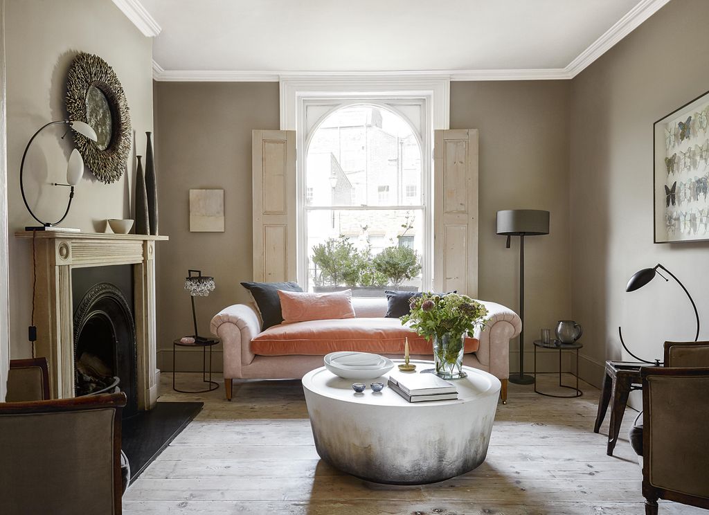 Image may contain Flooring Living Room Indoors Room Furniture Couch Floor Table Rug and Wood