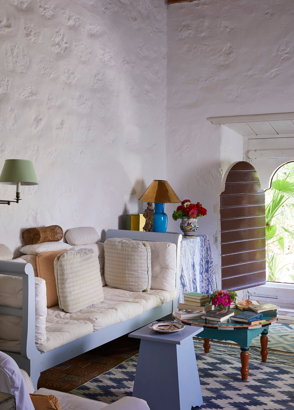 Image may contain Furniture Living Room Room Indoors Couch Interior Design Table Coffee Table Lamp and Table Lamp