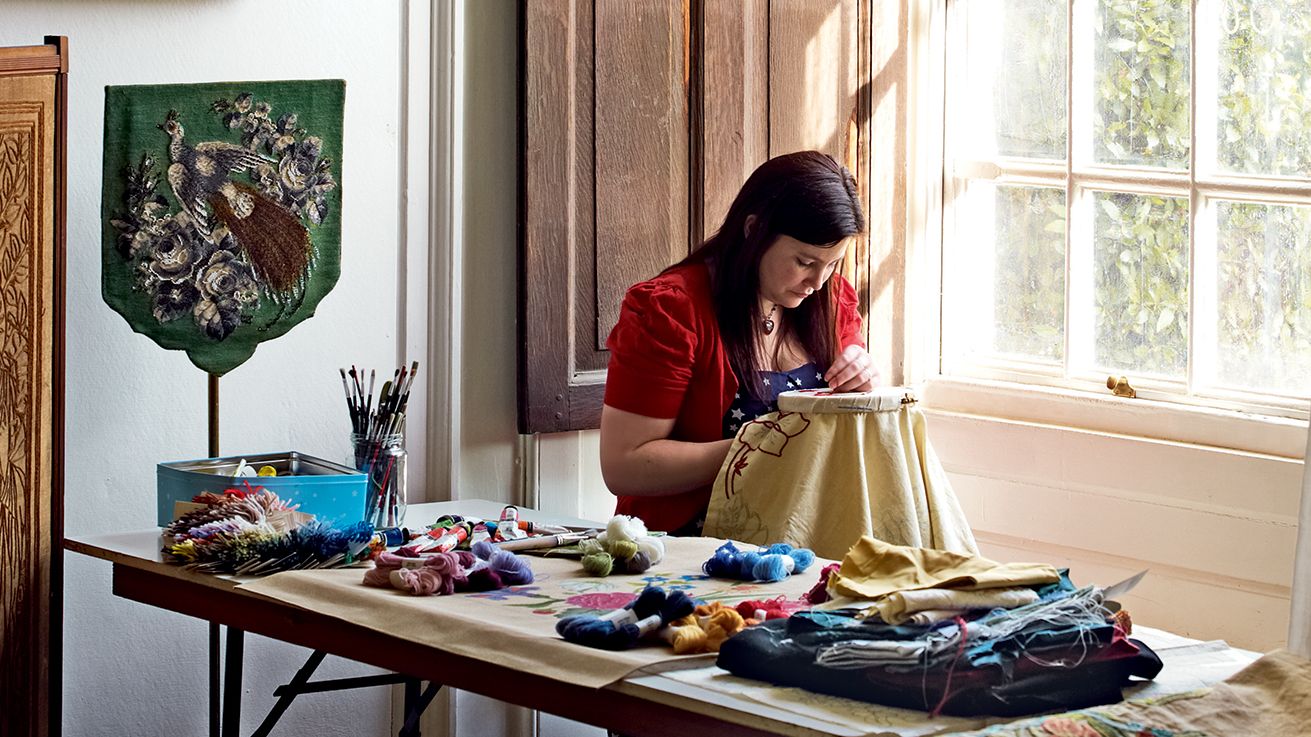 Image may contain Human Person Furniture Room Indoors Table and Wood