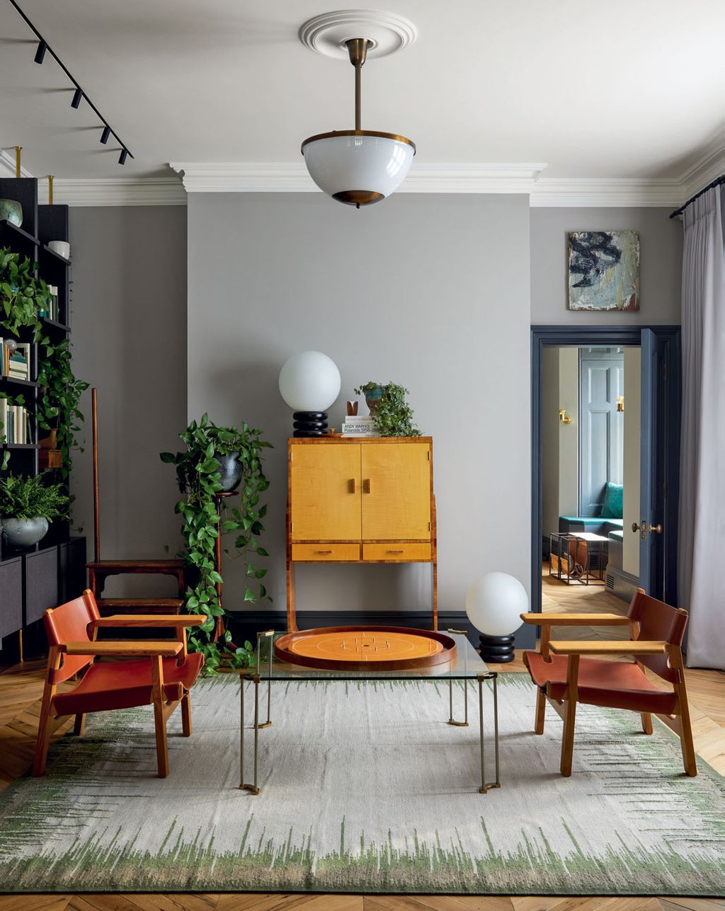 Image may contain Furniture Living Room Indoors Room Couch Interior Design Table Home Decor Flooring Rug and Wood