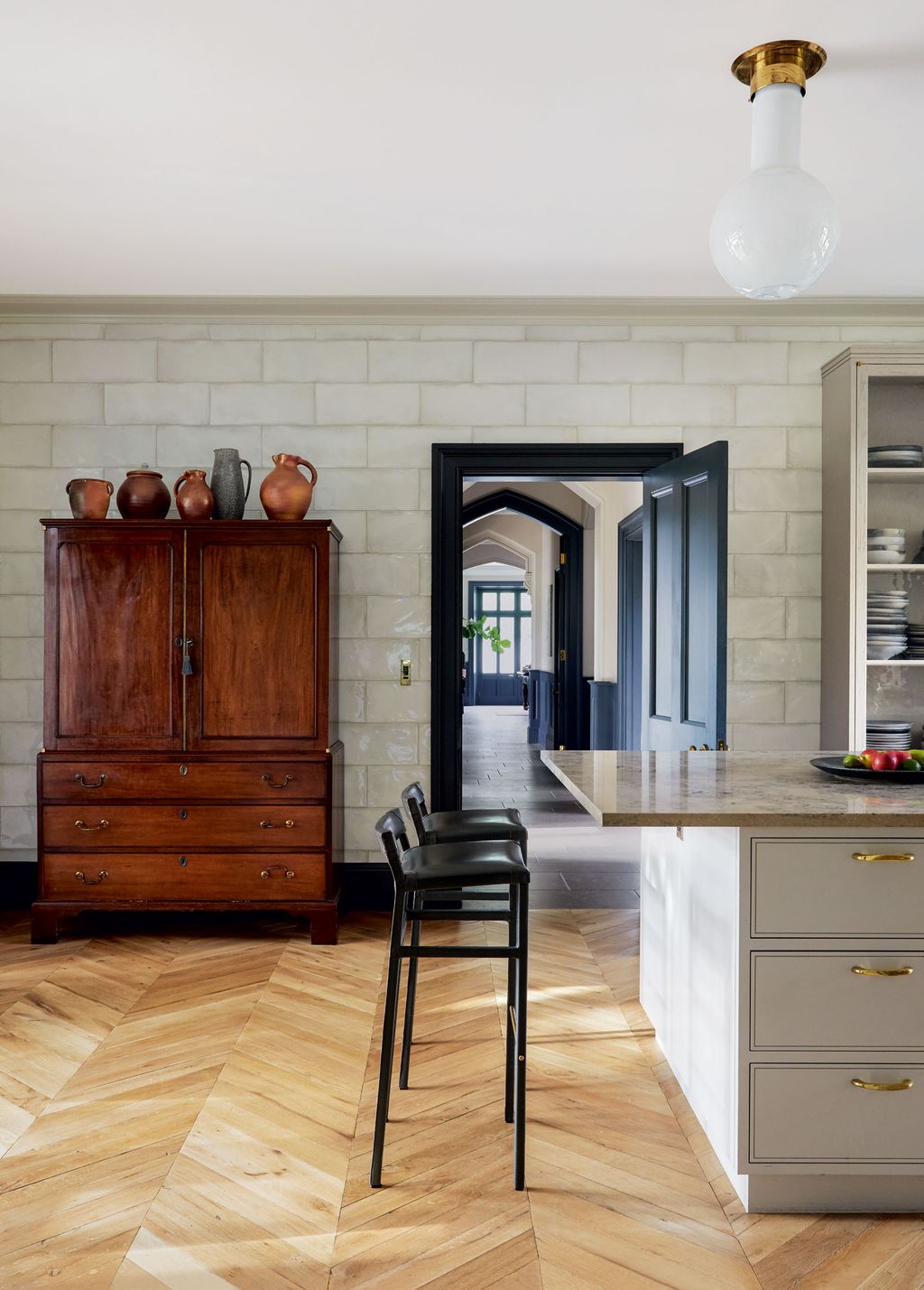 Wall tiles from Domus and parquet flooring from White  White provide the backdrop for a Regency mahogany linen press and...