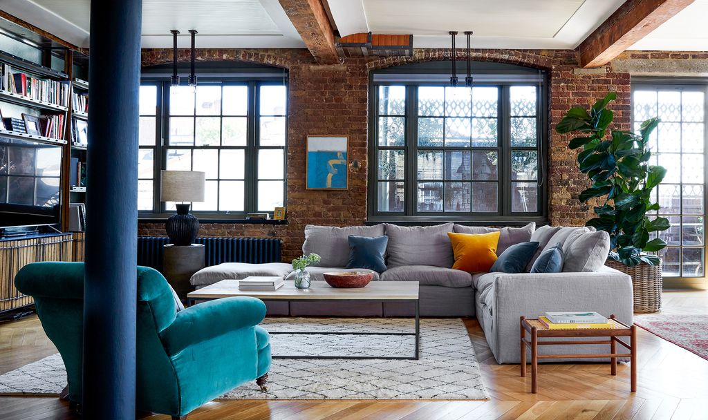 Image may contain Furniture Indoors Housing Building Living Room Room Couch Table Loft Rug and Coffee Table