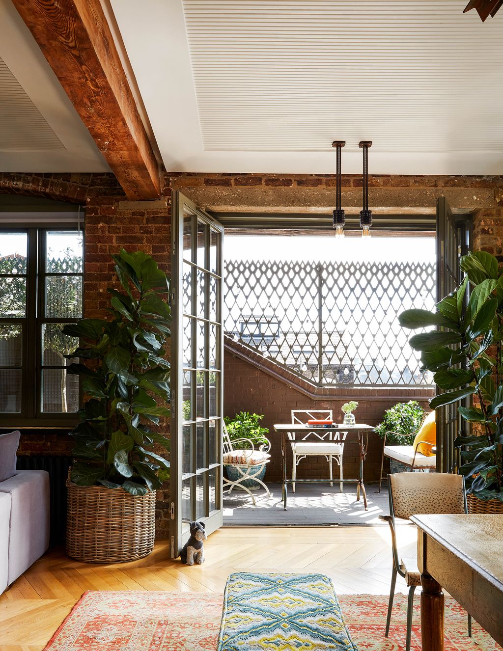 Image may contain Living Room Indoors Room Interior Design Furniture Couch Flooring Patio Rug and Wood