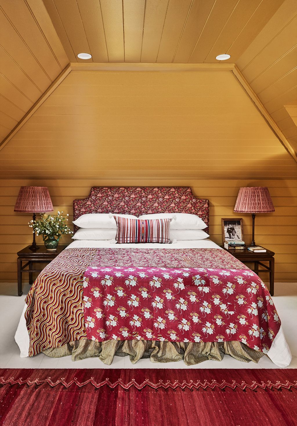 Image may contain Housing Building Lamp Table Lamp Indoors Interior Design Room Bedroom Rug Furniture and Loft