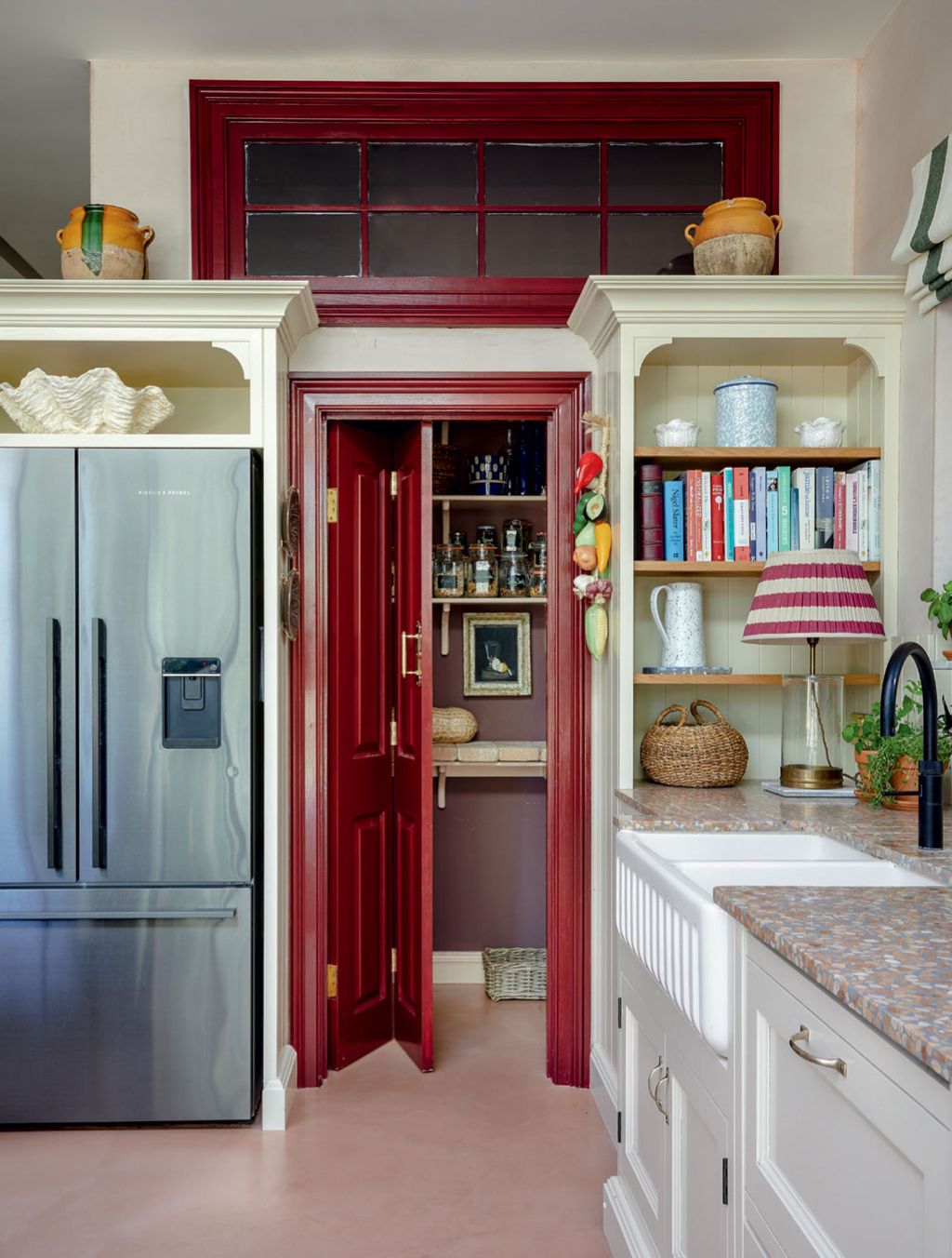 In the kitchen of Sarah CorbettWinders north London house an internal window introduces light into the larder which is...