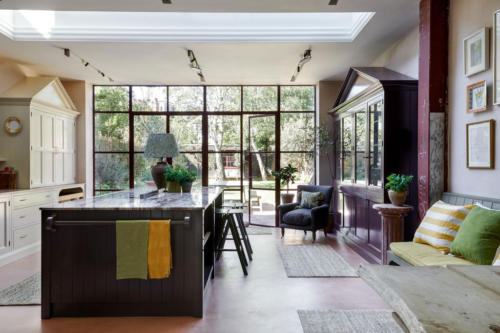 A large marbletopped island accommodates the oven as well as plenty of storage and is also used for informal meals. Two...