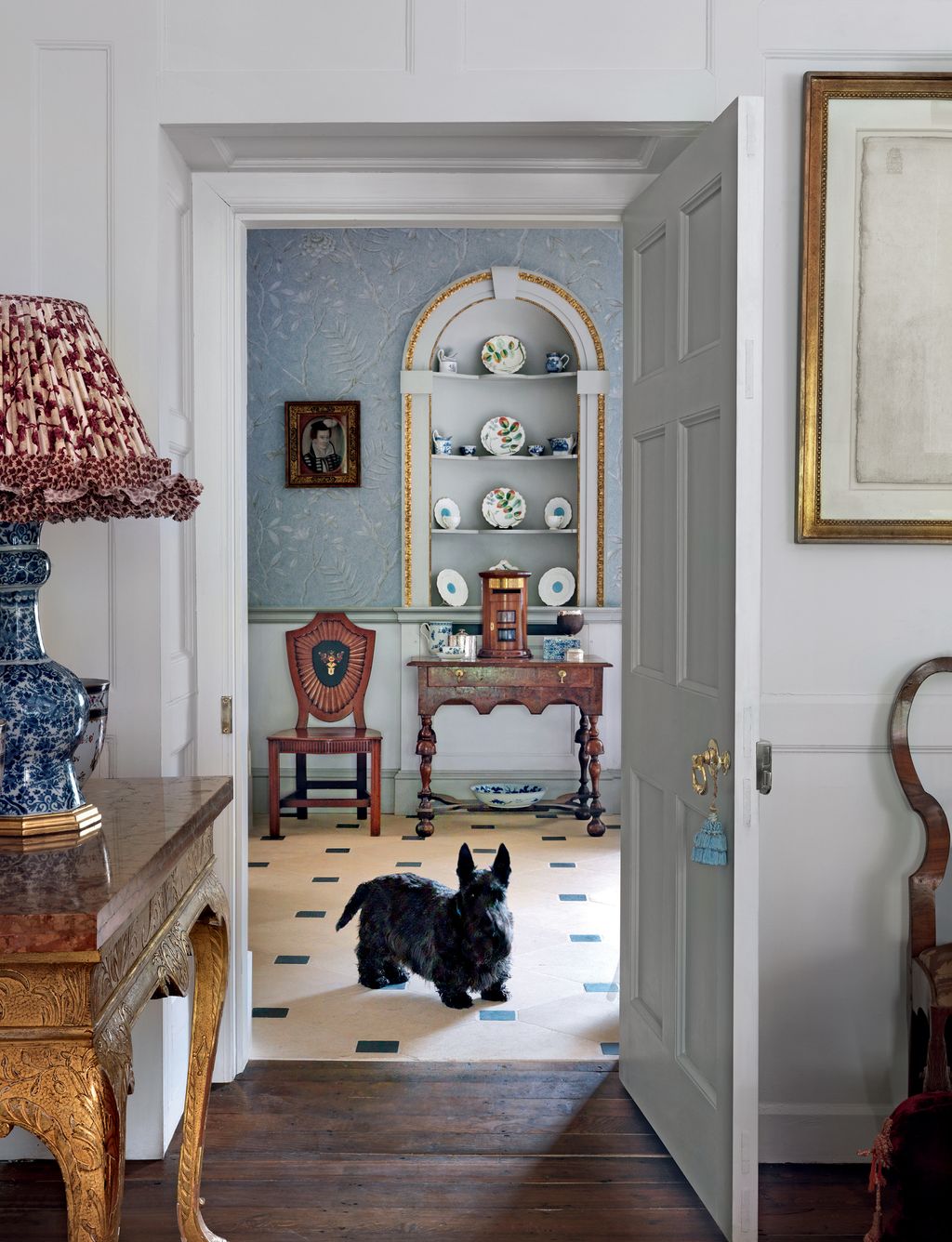 Image may contain Living Room Room Indoors Interior Design Flooring Shelf Furniture Floor Lamp and Table Lamp