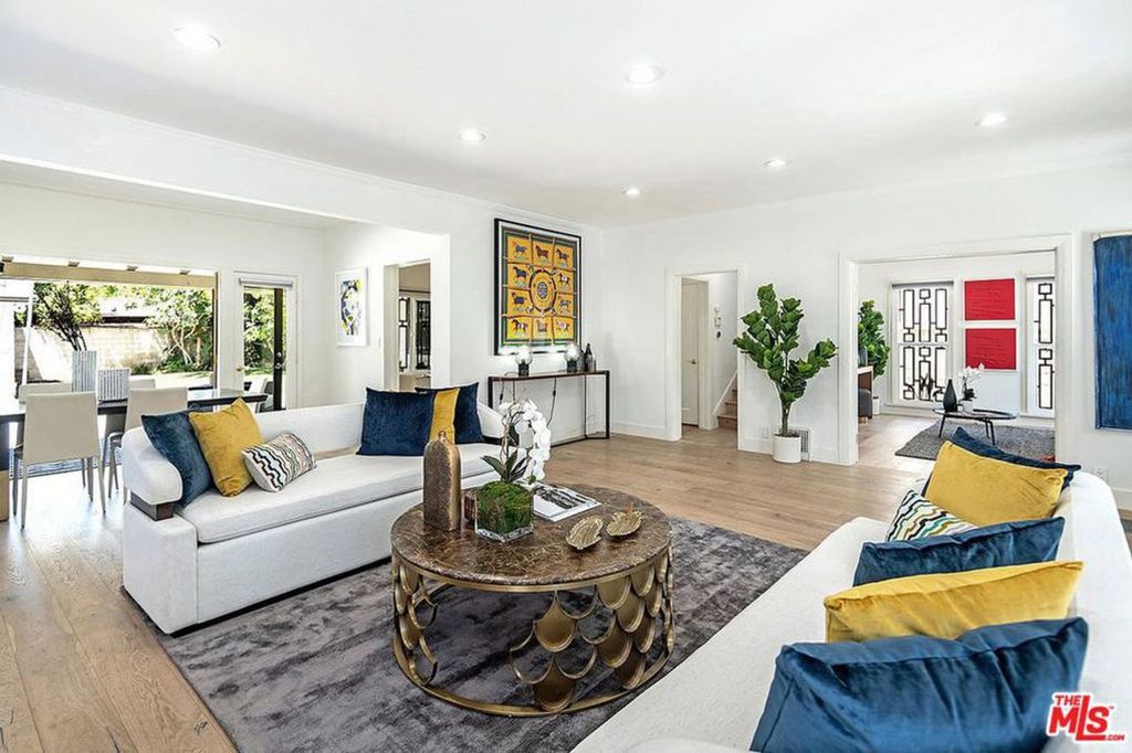 Image may contain Living Room Room Indoors Furniture Lobby Interior Design Rug Table Couch Home Decor and Housing