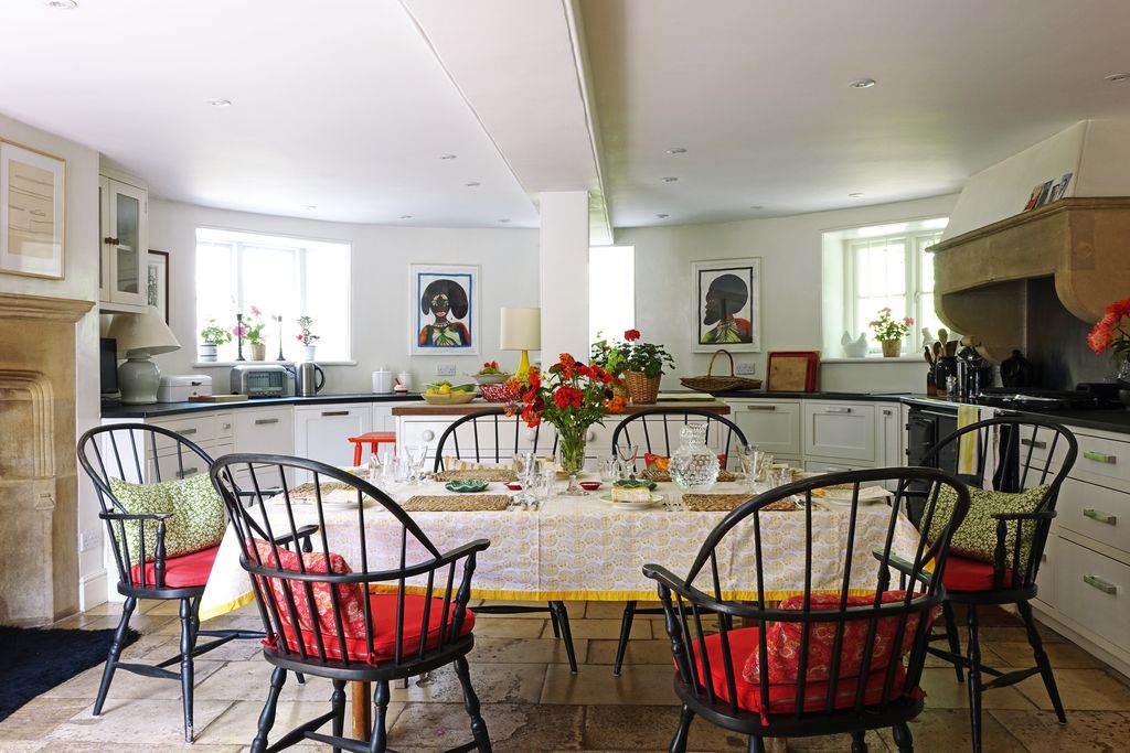 Image may contain Furniture Chair Flooring Human Person Indoors Interior Design Plant Living Room Room and Flower