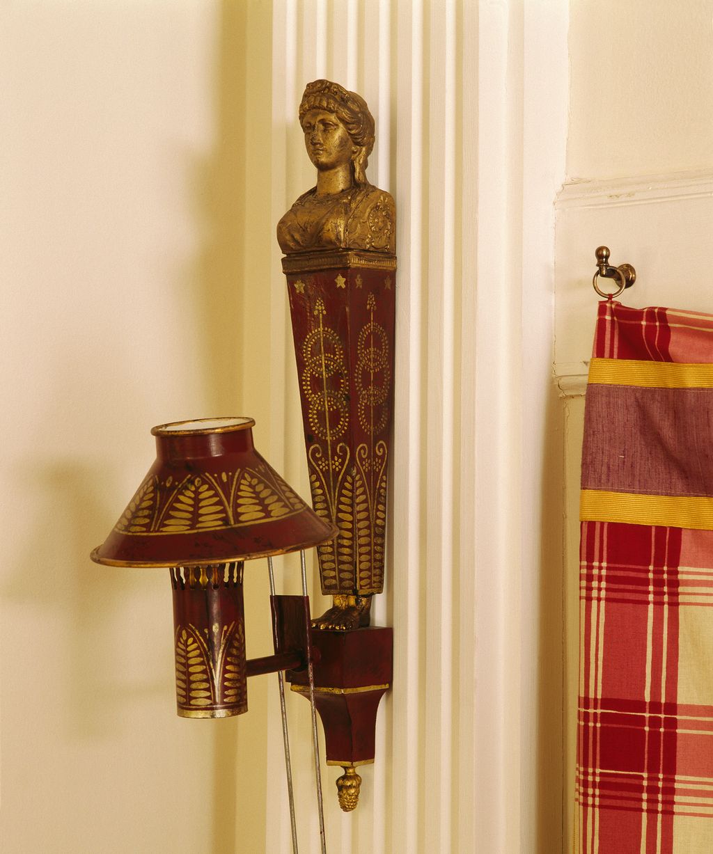 A rare lateeighteenth century painted tin wall lamp in the salon.