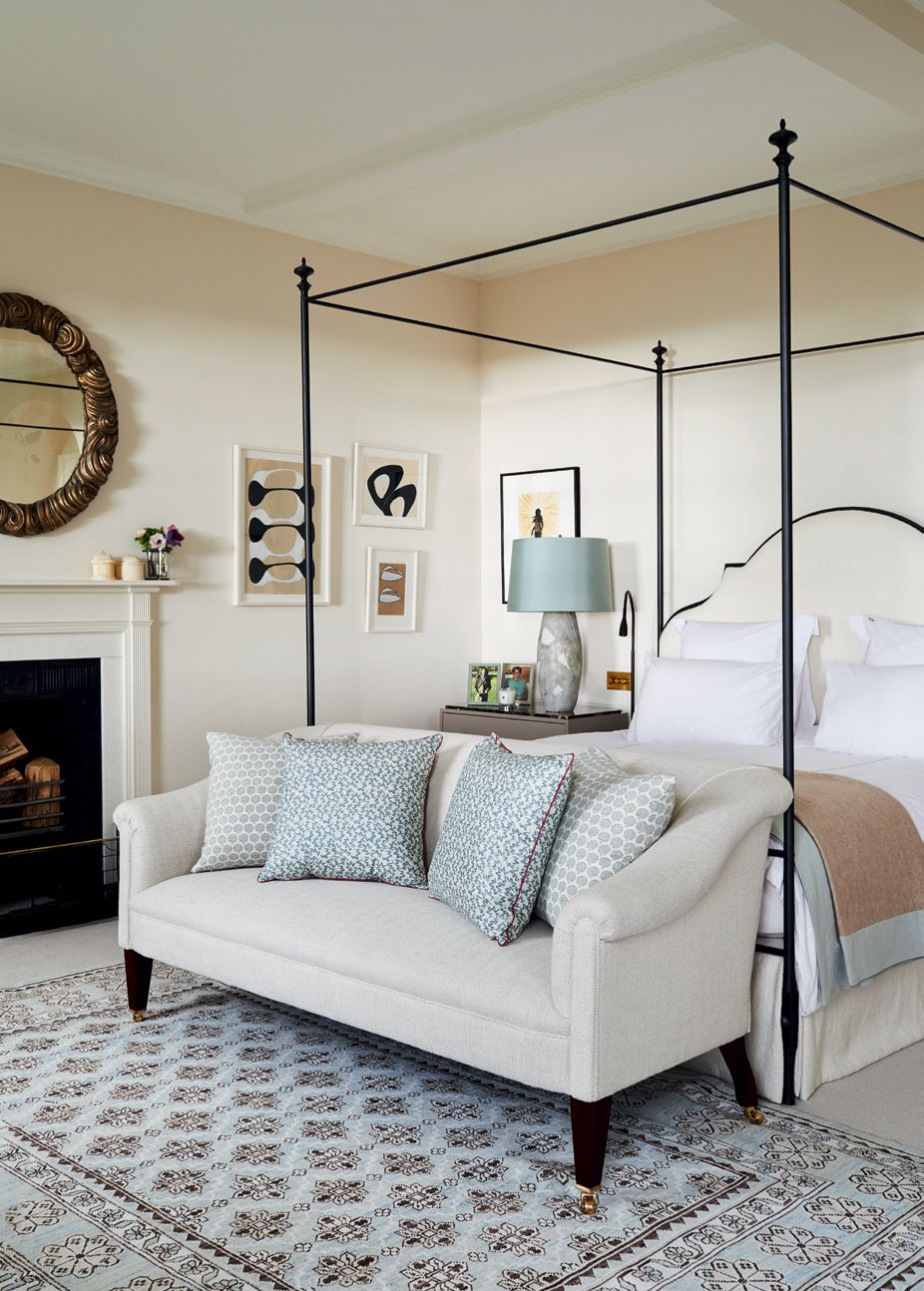 Image may contain Indoors Interior Design Furniture Rug Fireplace Living Room Room Hearth and Cushion