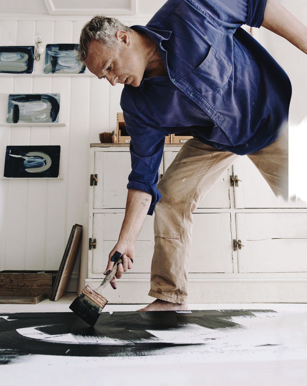 Image may contain Human Person Clothing Apparel Flooring Wood and Pants