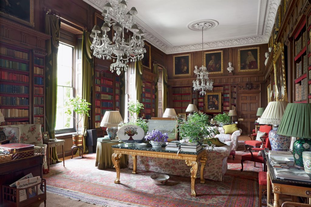 Image may contain Living Room Room Indoors Furniture Couch Table Lamp Chandelier Lobby and Flooring