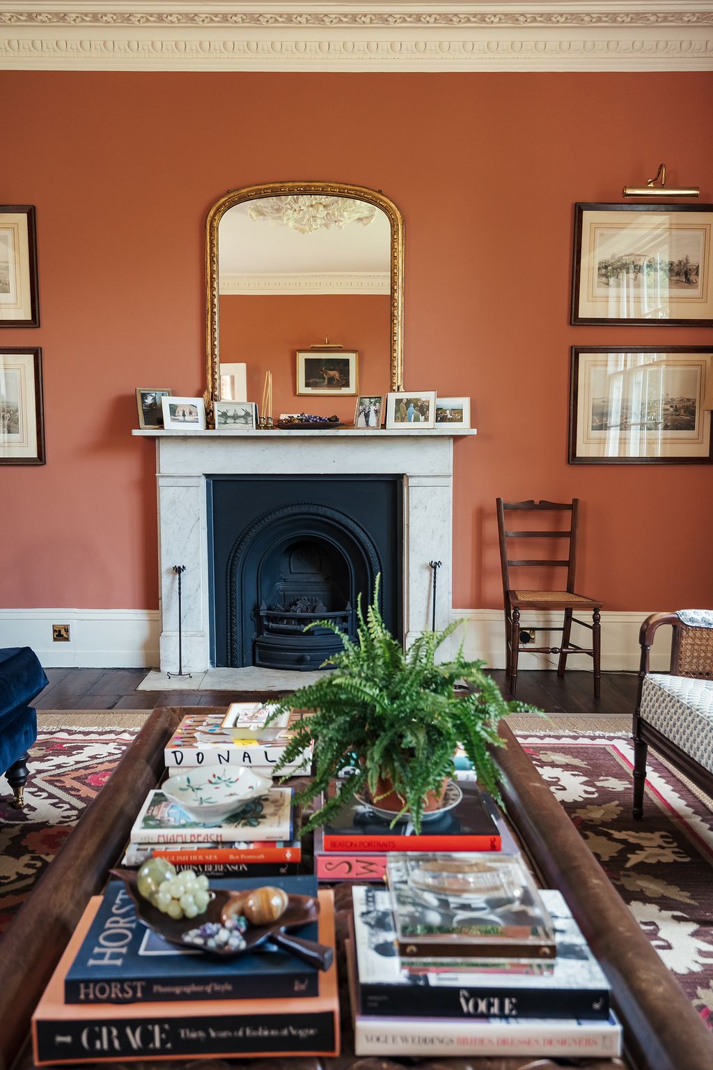 Image may contain Living Room Room Indoors Interior Design Fireplace Furniture Hearth Chair Home Decor and Couch