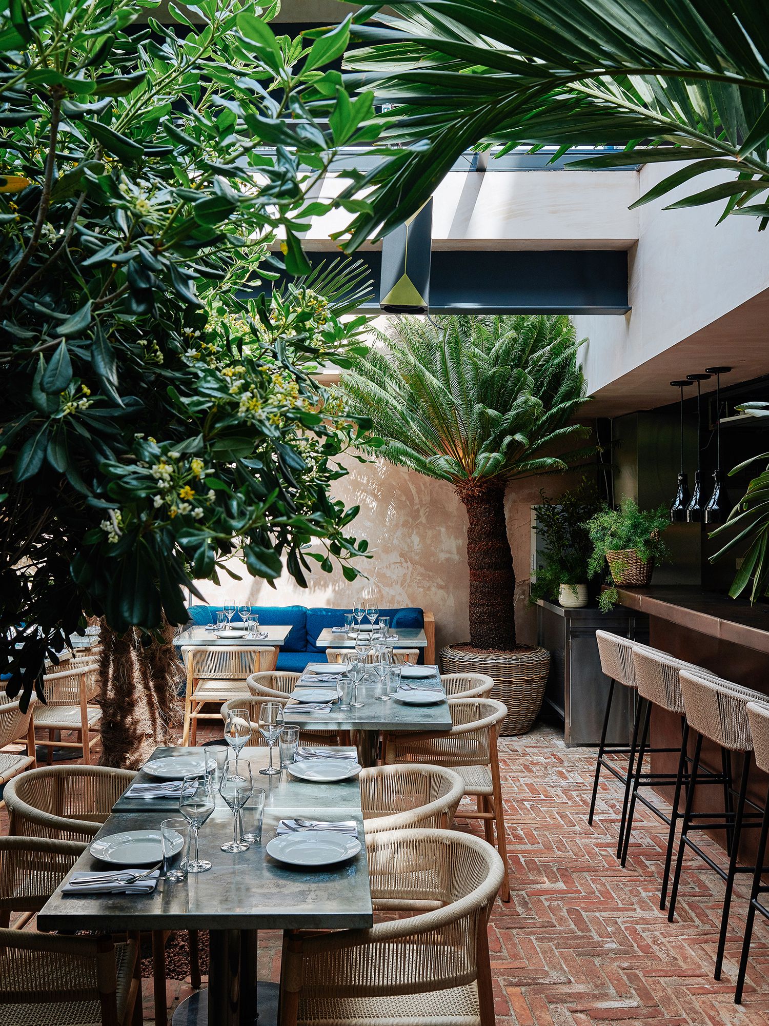 Image may contain Furniture Chair Restaurant Table Outdoors Cafe Dining Table and Patio